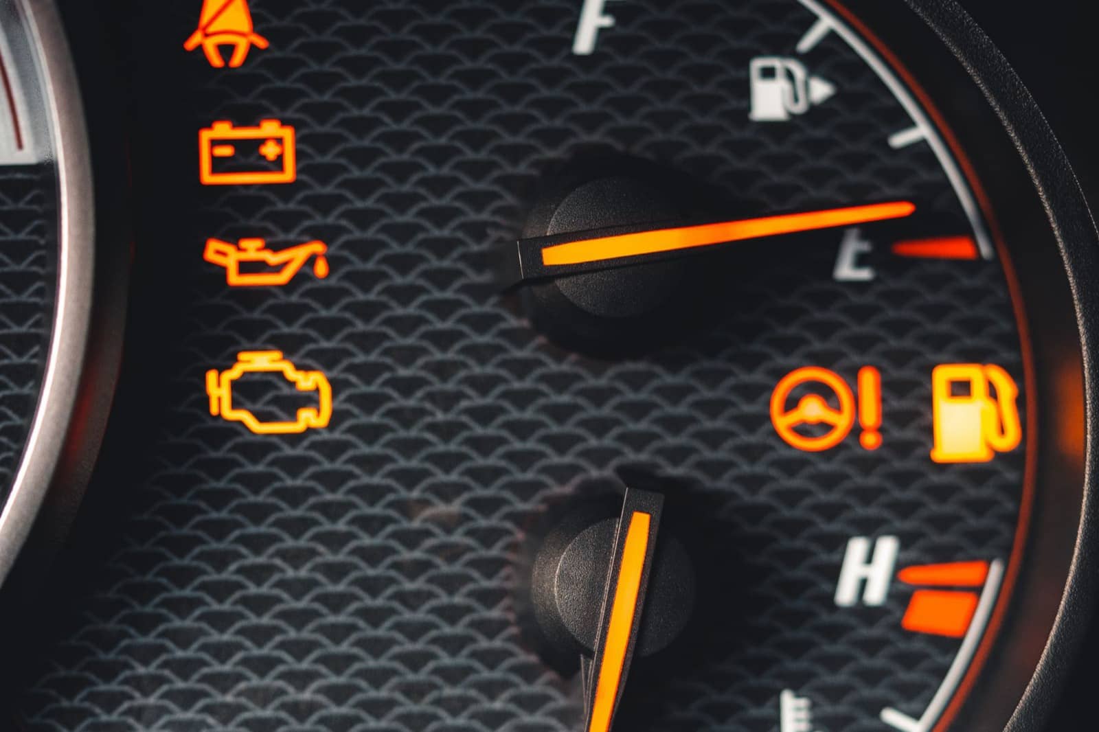 Instrument cluster with the check engine, battery and oil warning lights lit