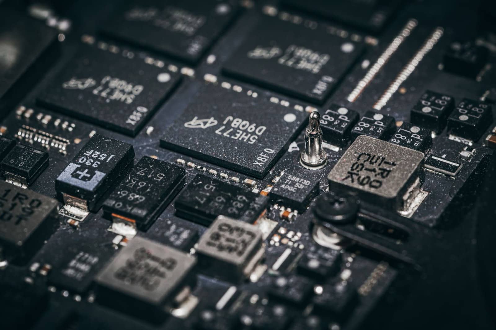 Close-up of chips and components on a dark electronic control board