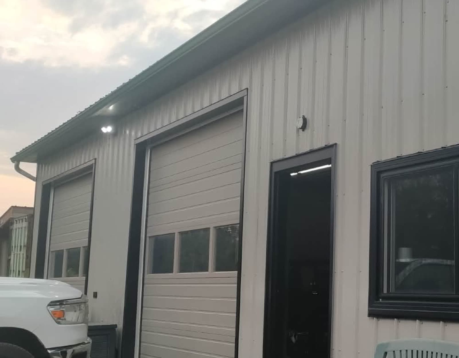 The two service bays at Berardocco Auto, 230 Colborne St in Welland, with the shop door open